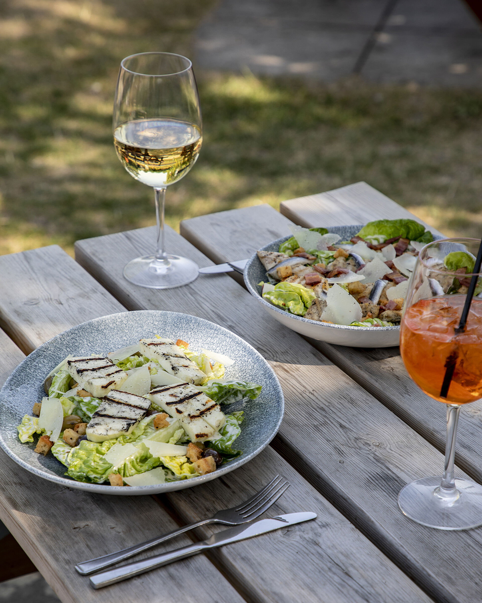 Halloumi Caesar salad with a glass of wine